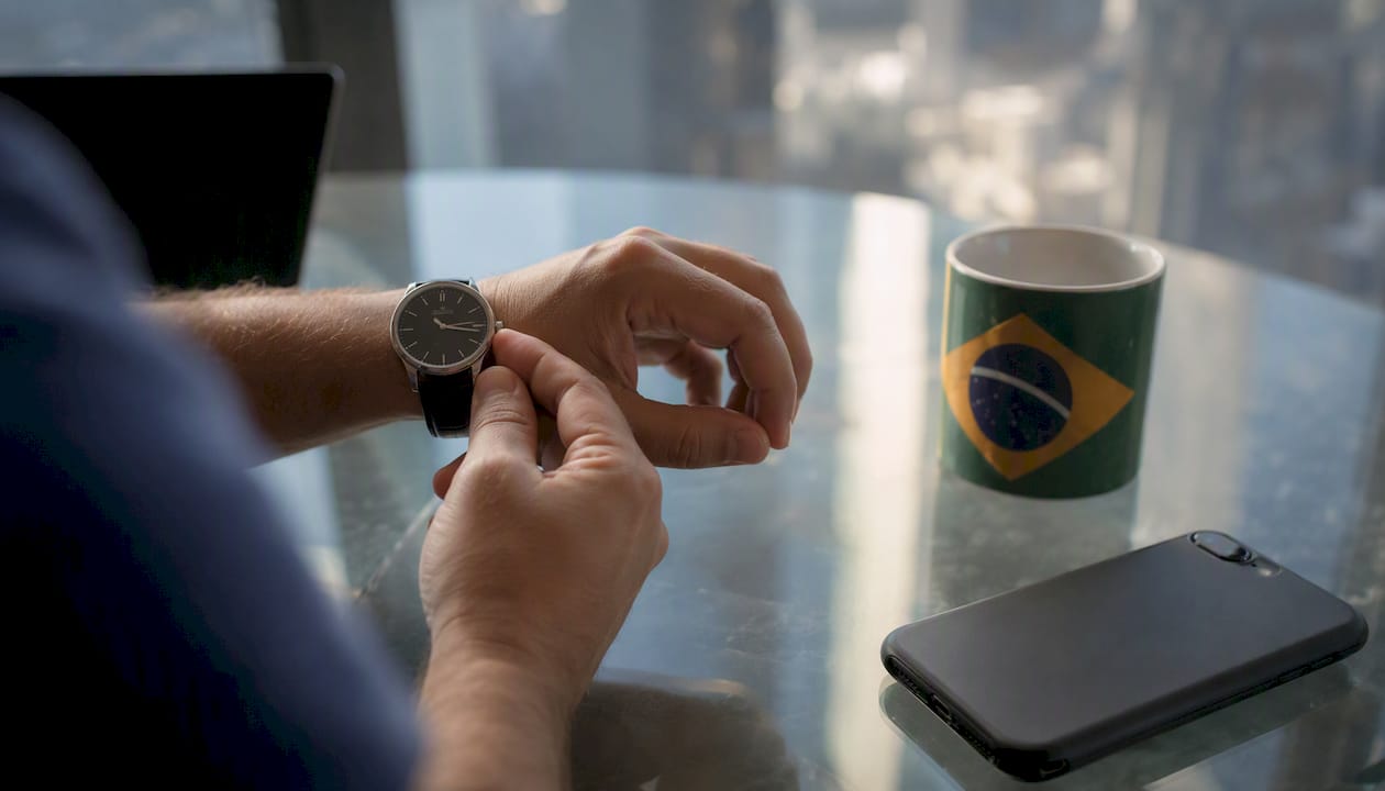 Hands setting wristwatch symbolizing time-zone overlap