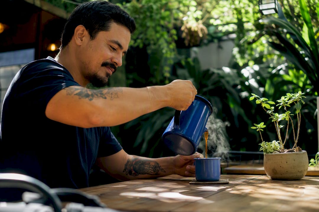 Brazilian professional pouring coffee on office table