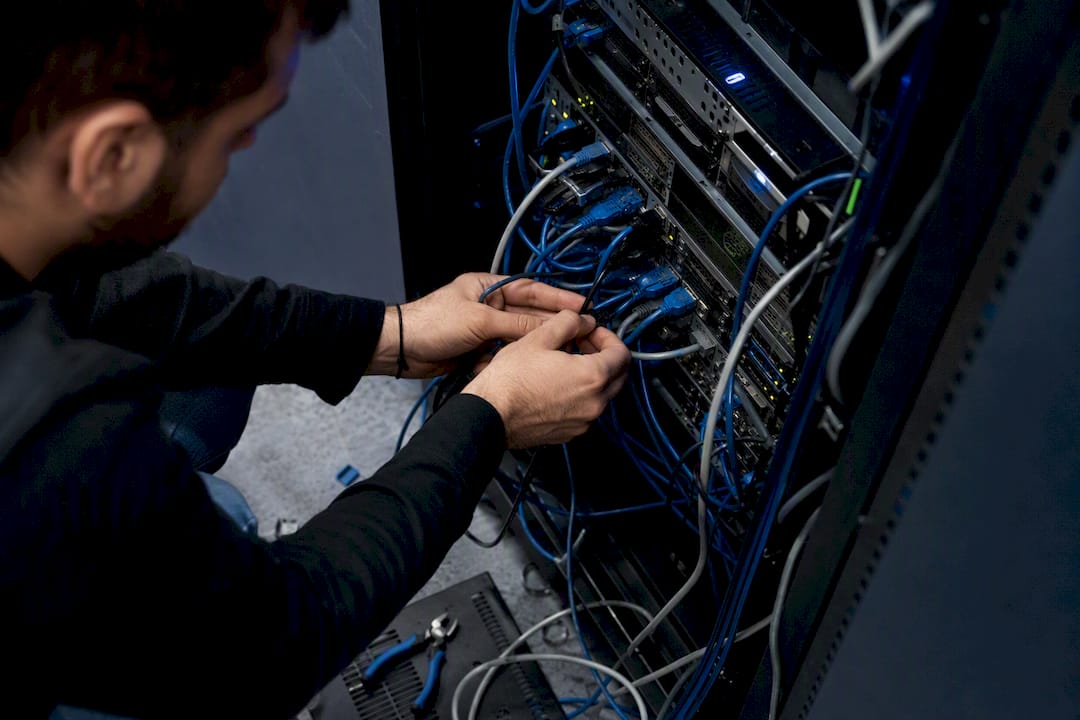 QA engineer hands wiring server rack cables