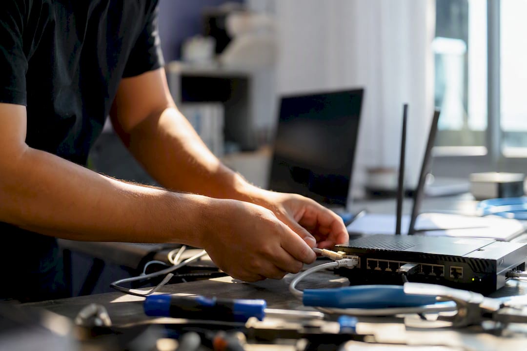 Engineer wiring network device in tech lab
