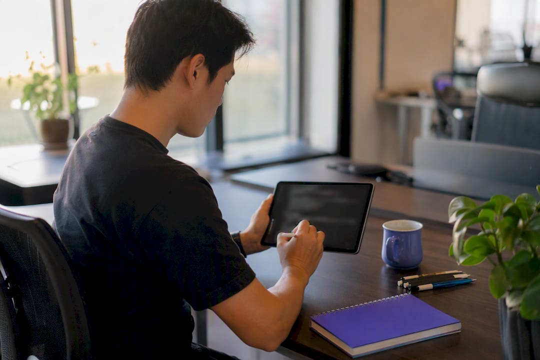 Hands writing test code on a tablet